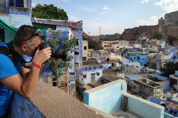 A man taking a photo of the blue houses in Jodhpur